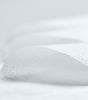 Close-up of white fabric with folds and texture
