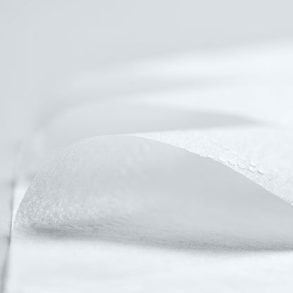 Close-up of white fabric with folds and texture