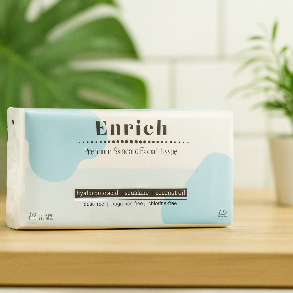 Enrich premium skincare facial tissue box on a wooden surface with plants in the background