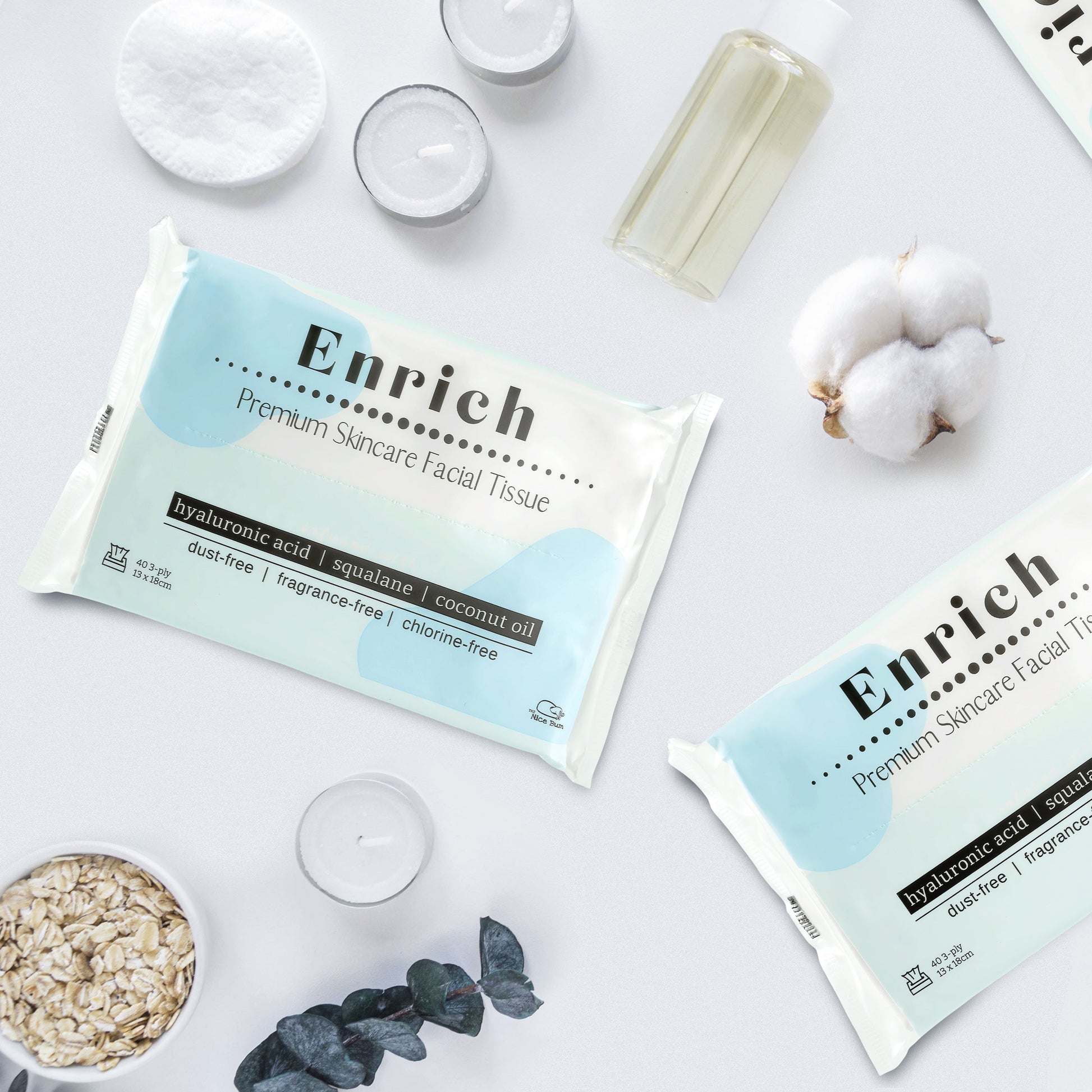 Enrich facial tissue packages on a light background with cotton and other items.