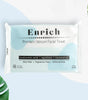 A pack of Enrich premium skincare facial tissues, with packaging that highlights features such as hylauronic acid, squalene, and coconut oil. The pack is white with blue and green design elements, and there are coconut oil plants in the background.