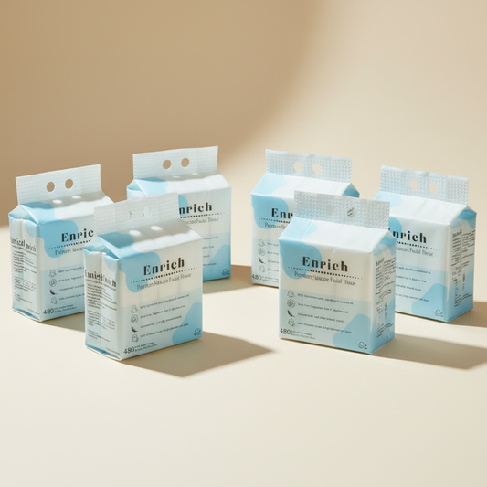 Multiple bags of Enrich facial tissue with zero dust on a beige background