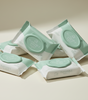 Multiple packages of edi water infused clean flushable wipes on a light background