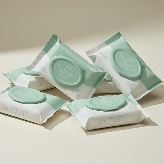 Multiple packages of edi water infused clean flushable wipes on a light background