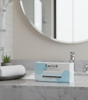 Box of Enrich facial tissues on a bathroom counter with a mirror in the background